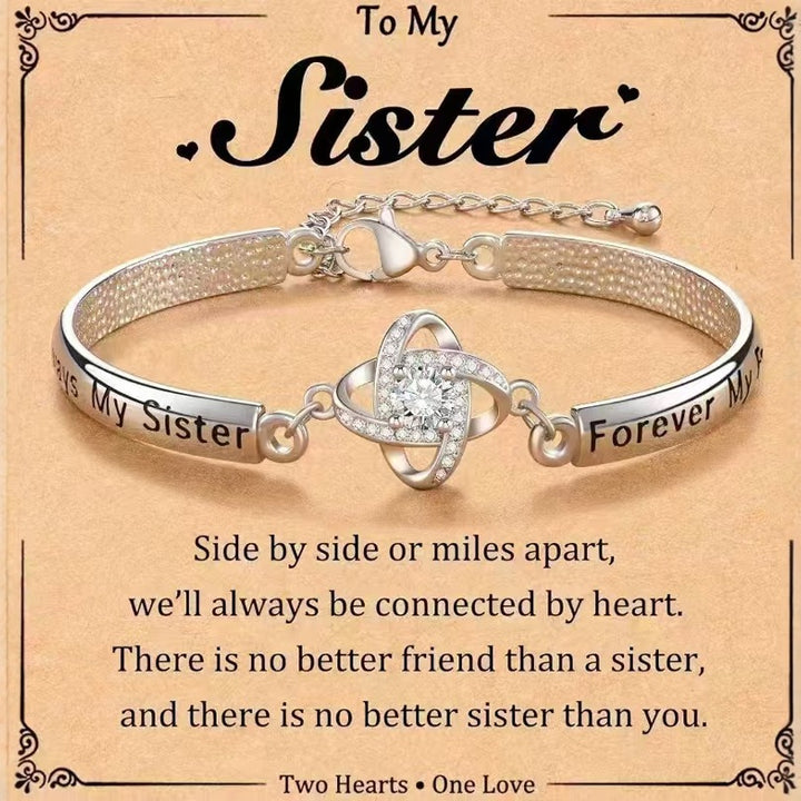 Four-leaf clover charm bracelet with floral detail